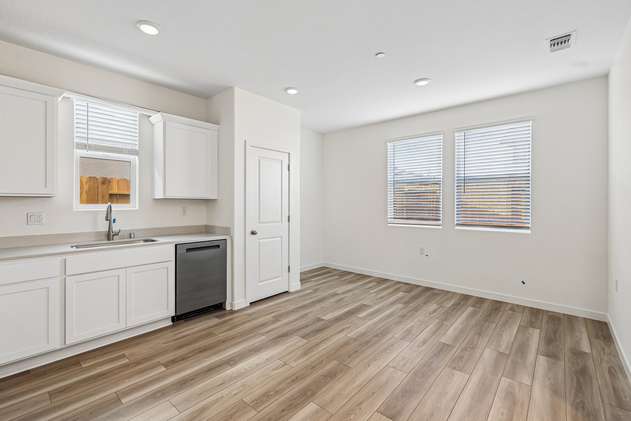 A kitchen with white cabinets.