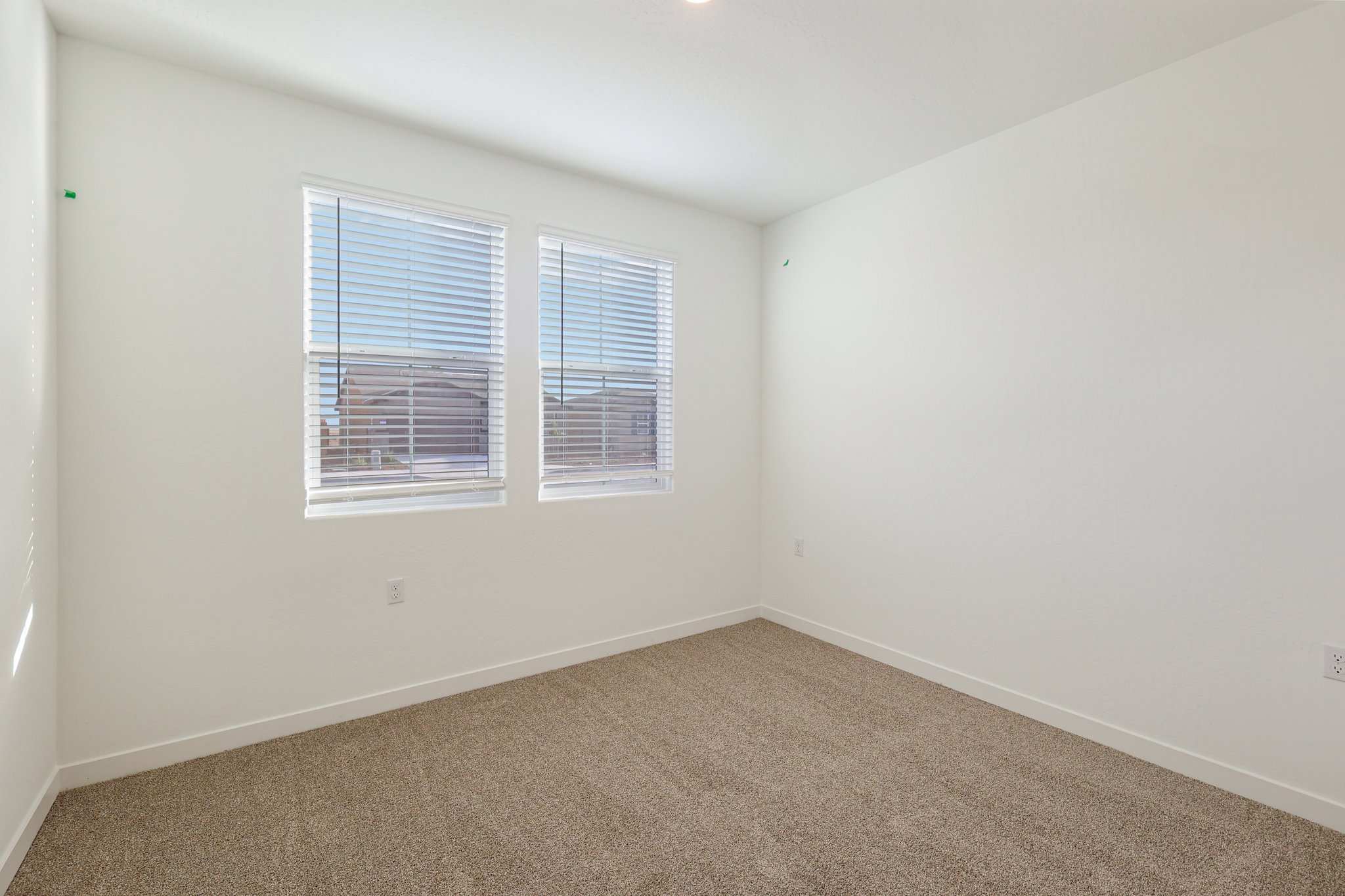 A room with a window and a carpet.