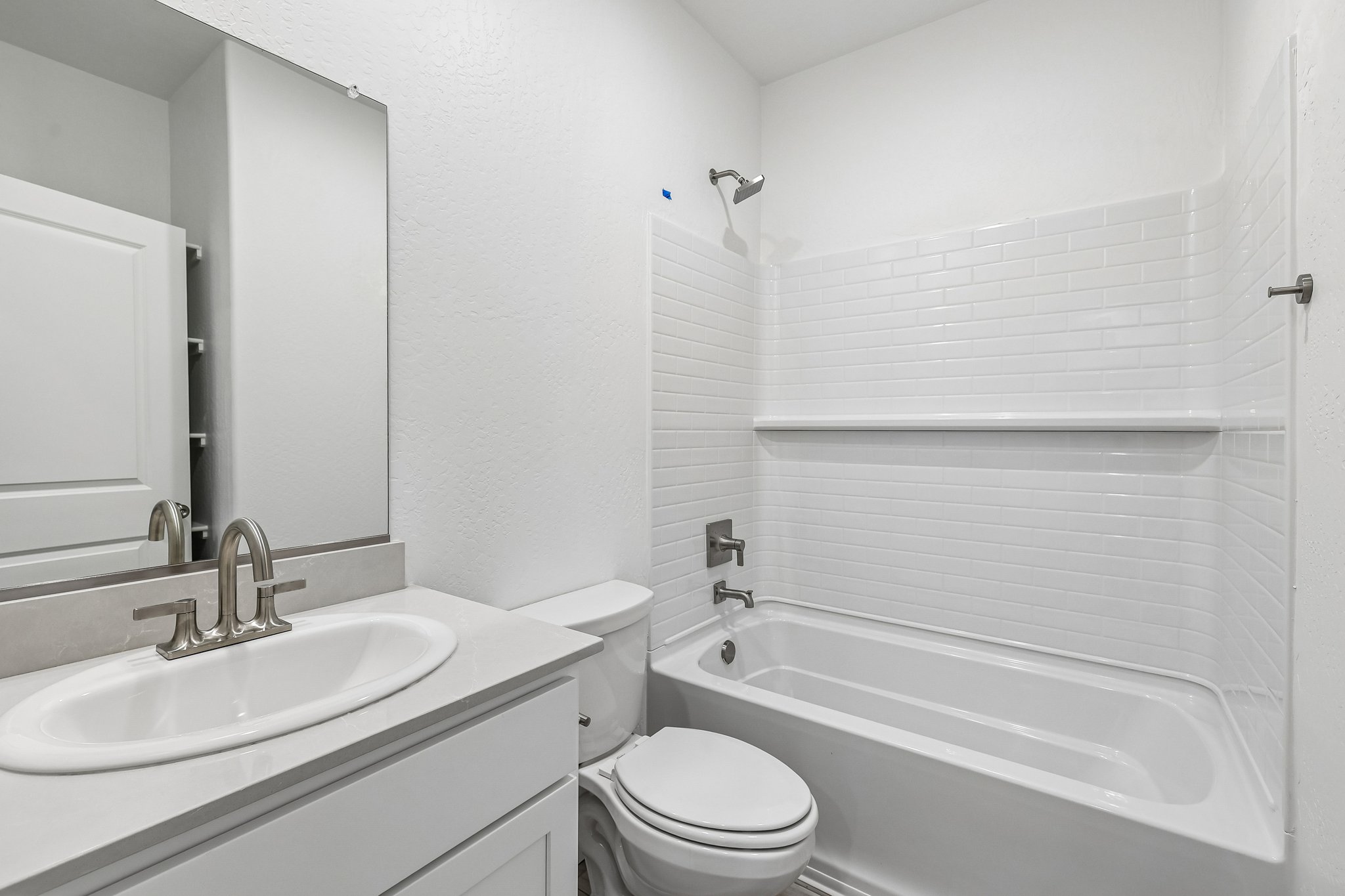 A bathroom with a sink toilet and bathtub.