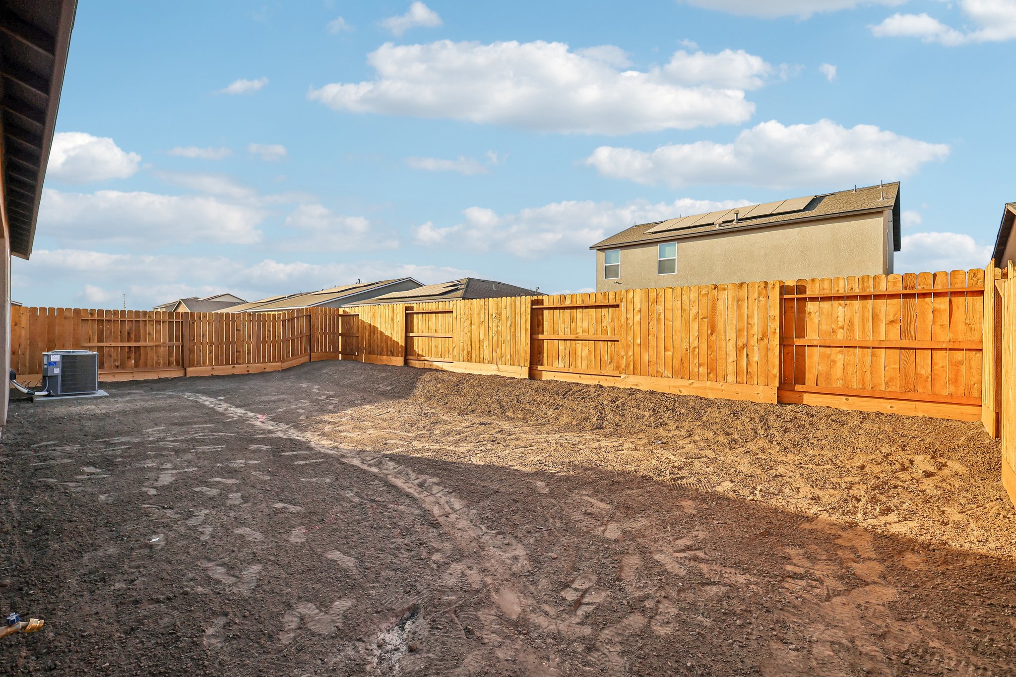 A fenced off area with a building in the background.