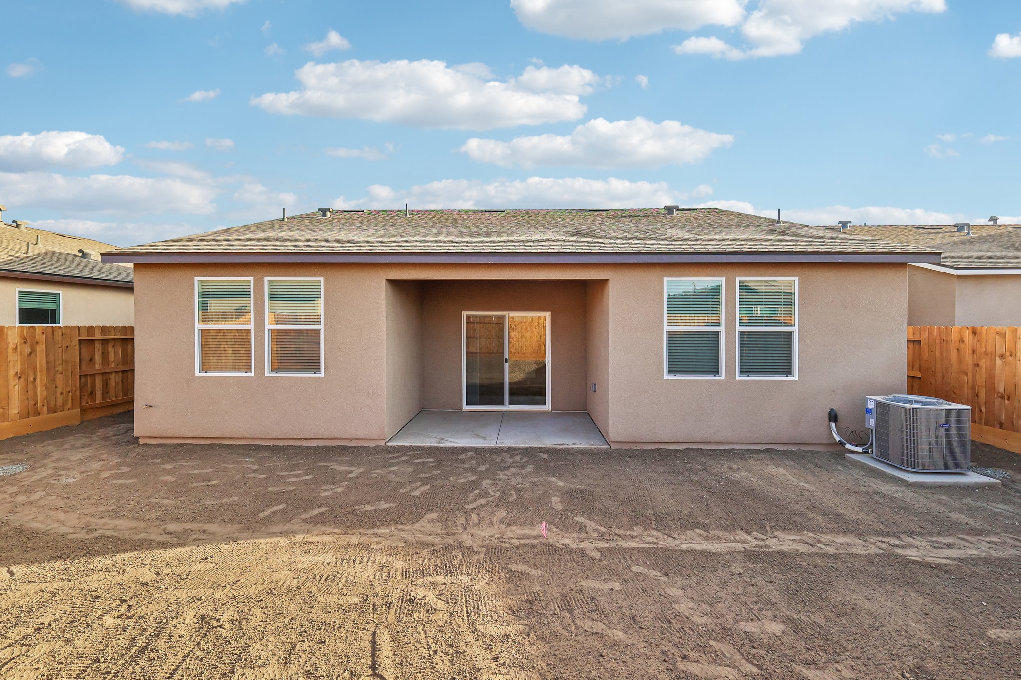 A building with a dirt yard.