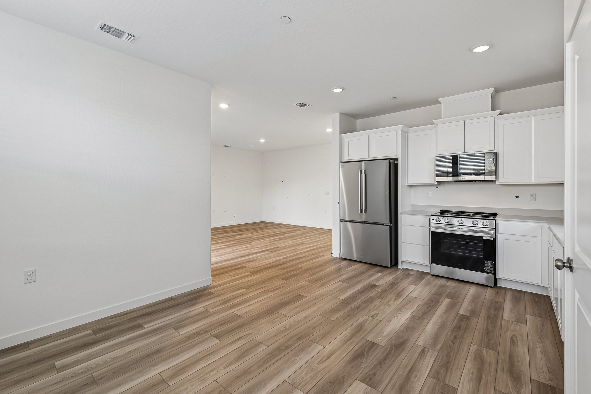 A kitchen with white cabinets.