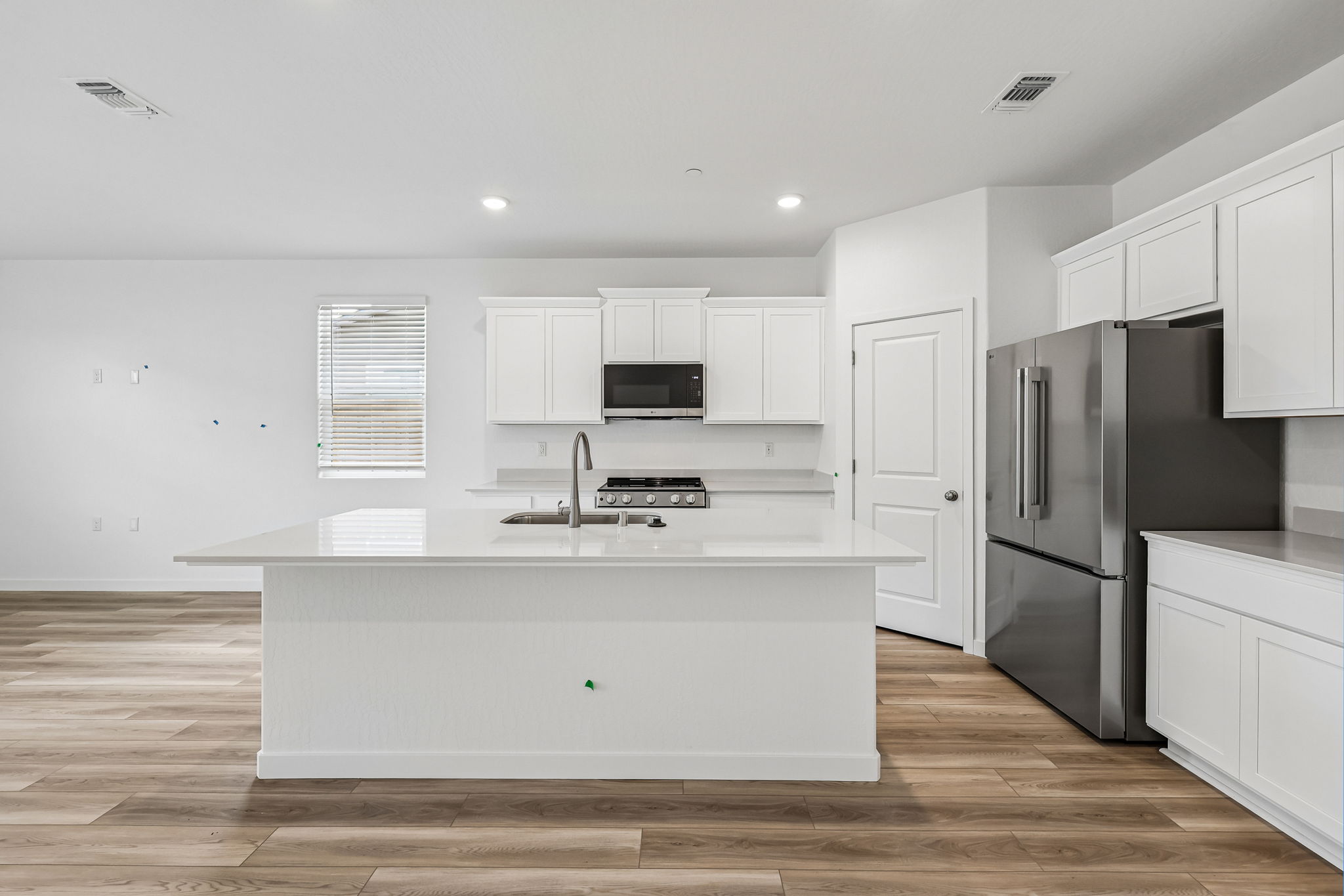 A kitchen with white cabinets.