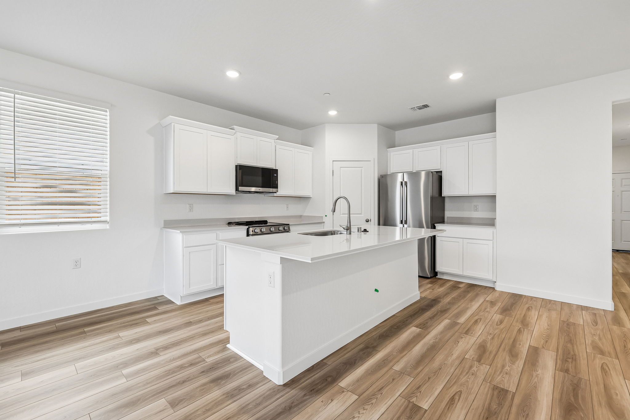 A kitchen with white cabinets.