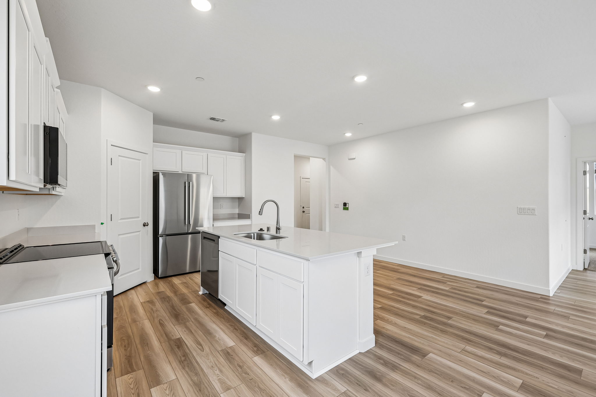 A kitchen with white cabinets.