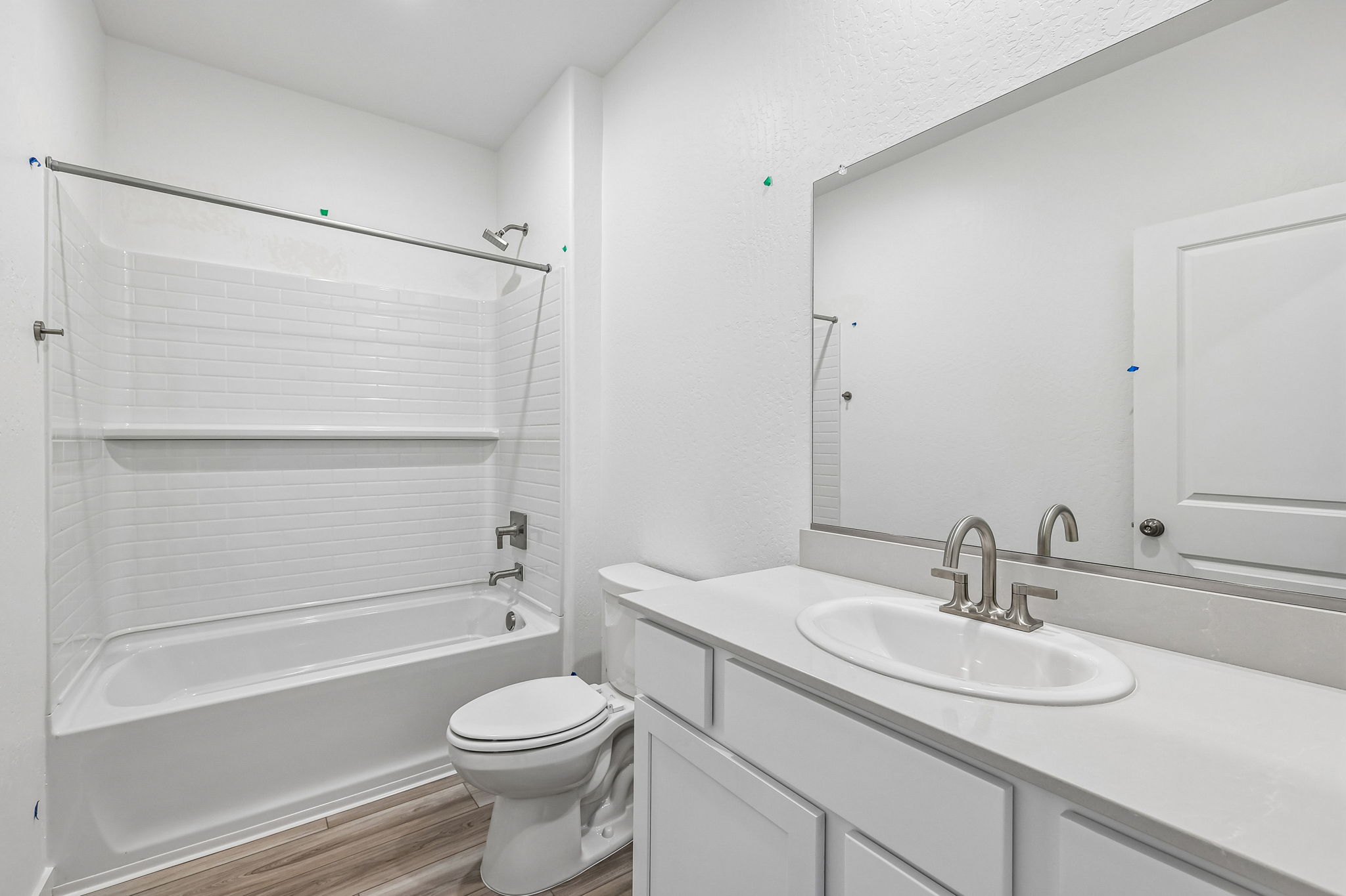 A bathroom with a sink toilet and bathtub.