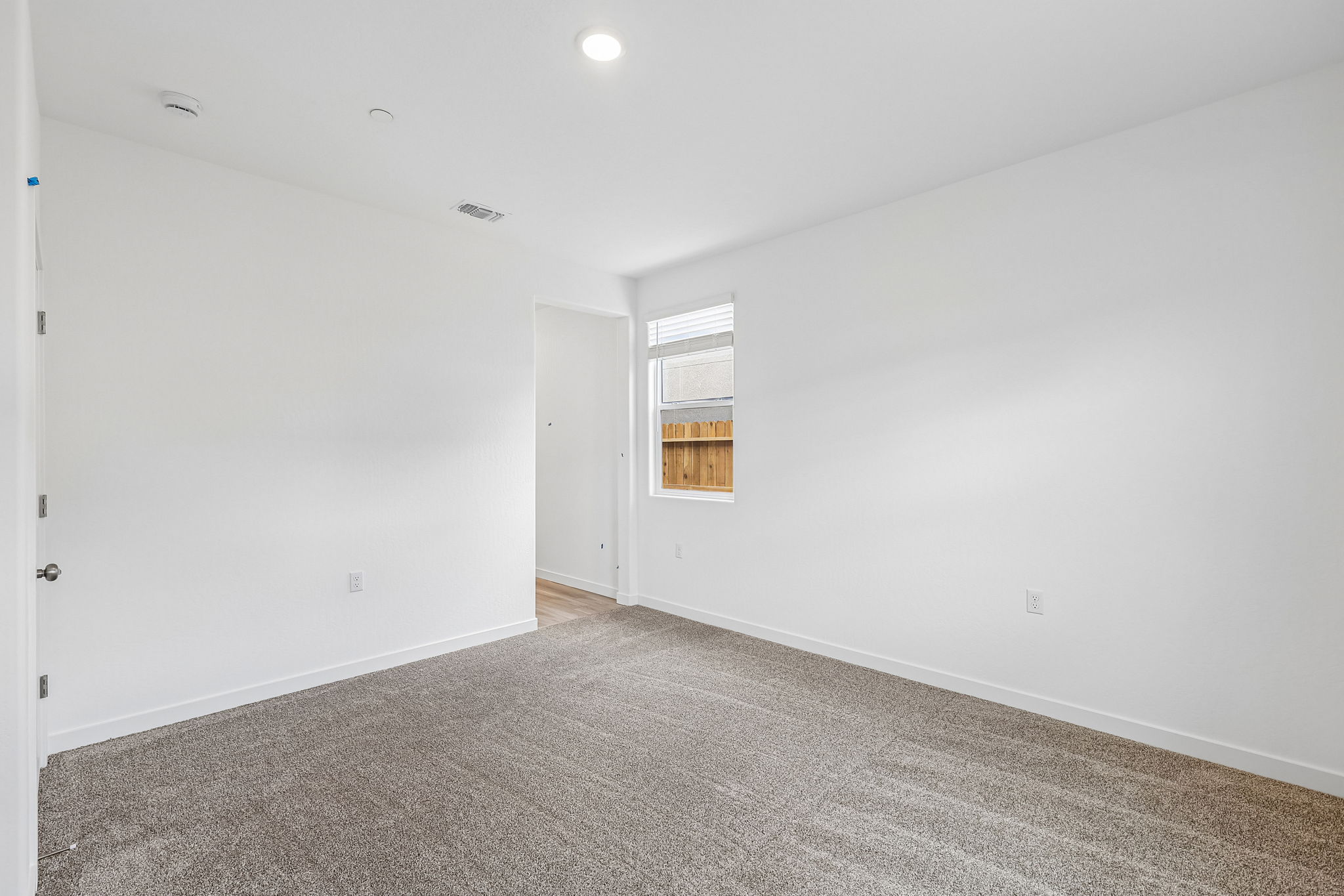 A room with a door and windows.