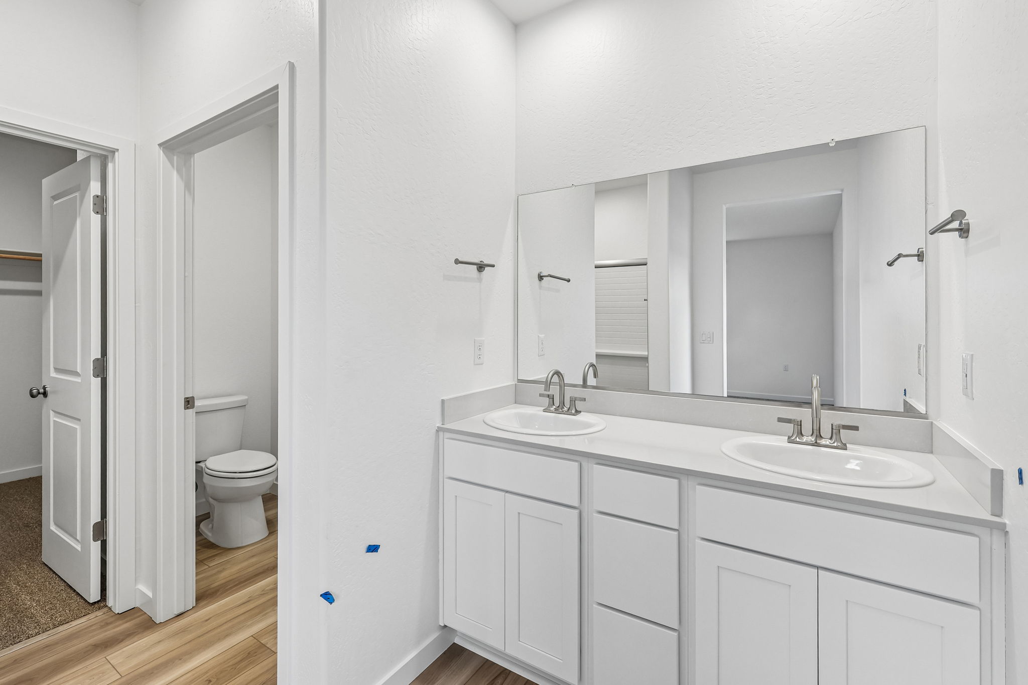 A bathroom with white cabinets.