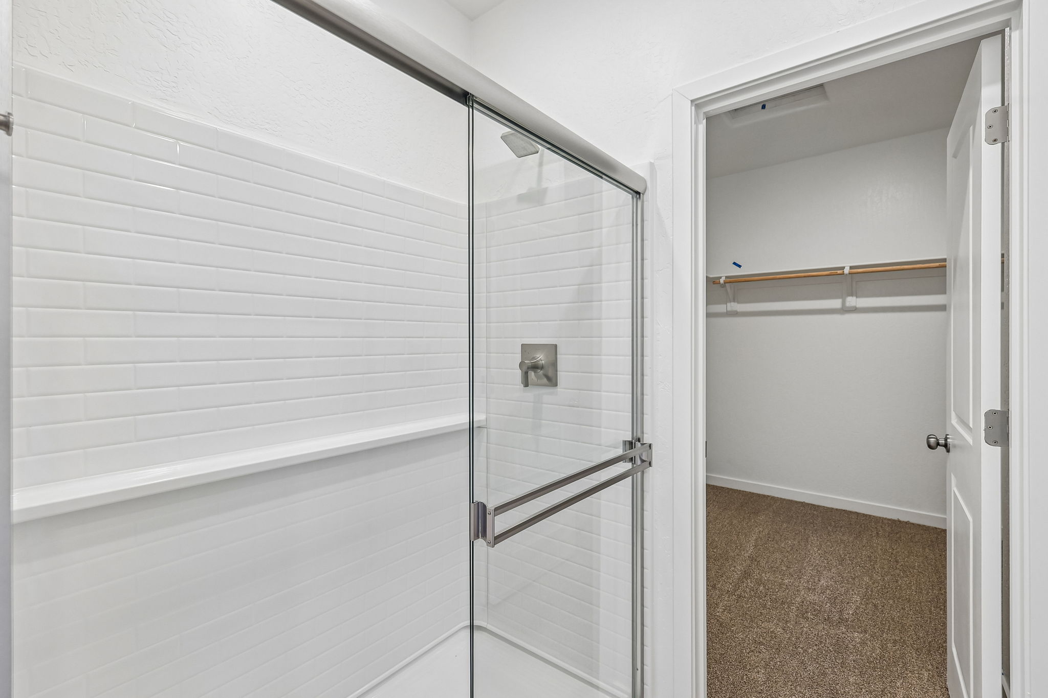 A shower with a glass door.