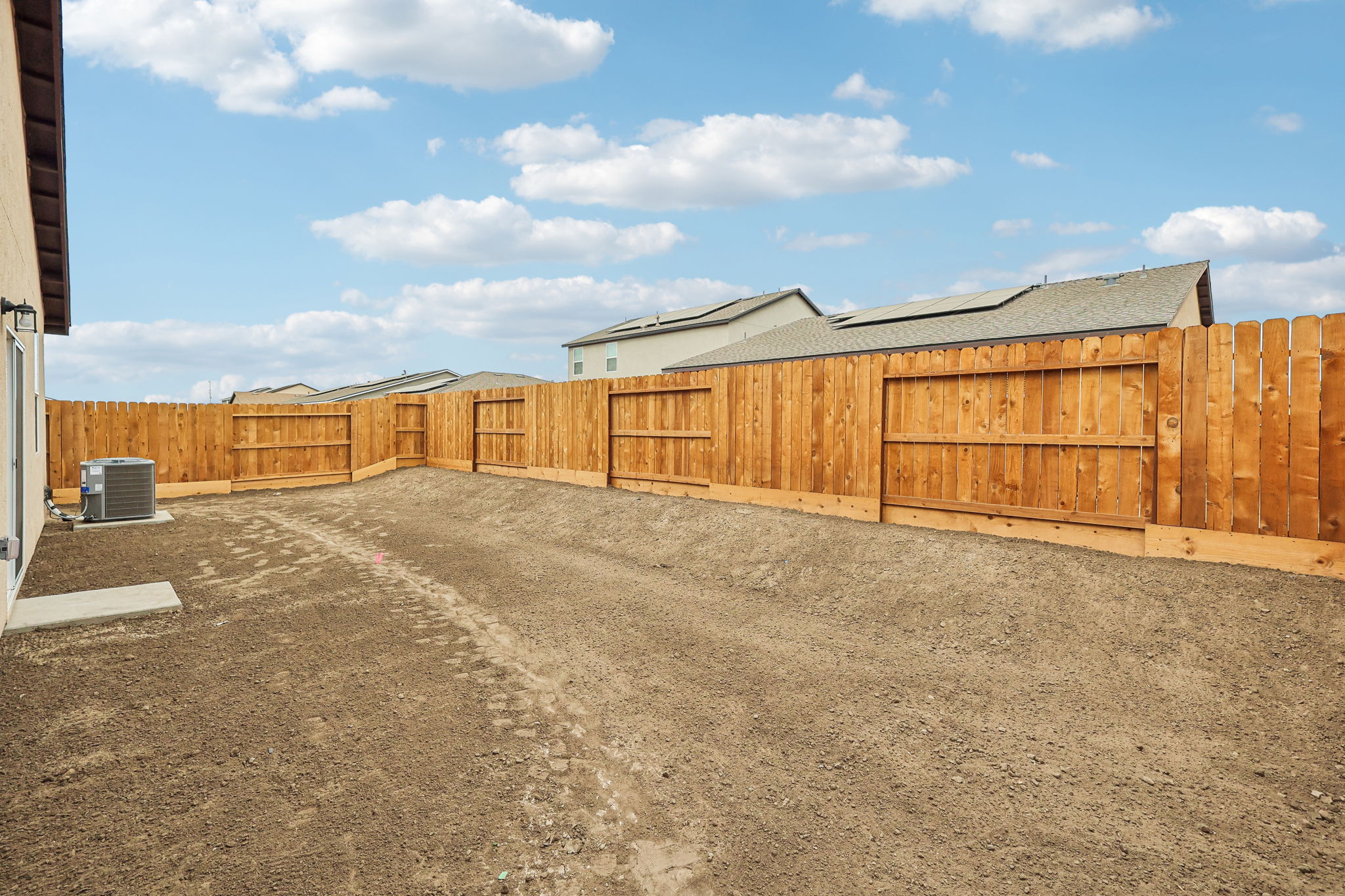 A fenced off area with a building in the background.