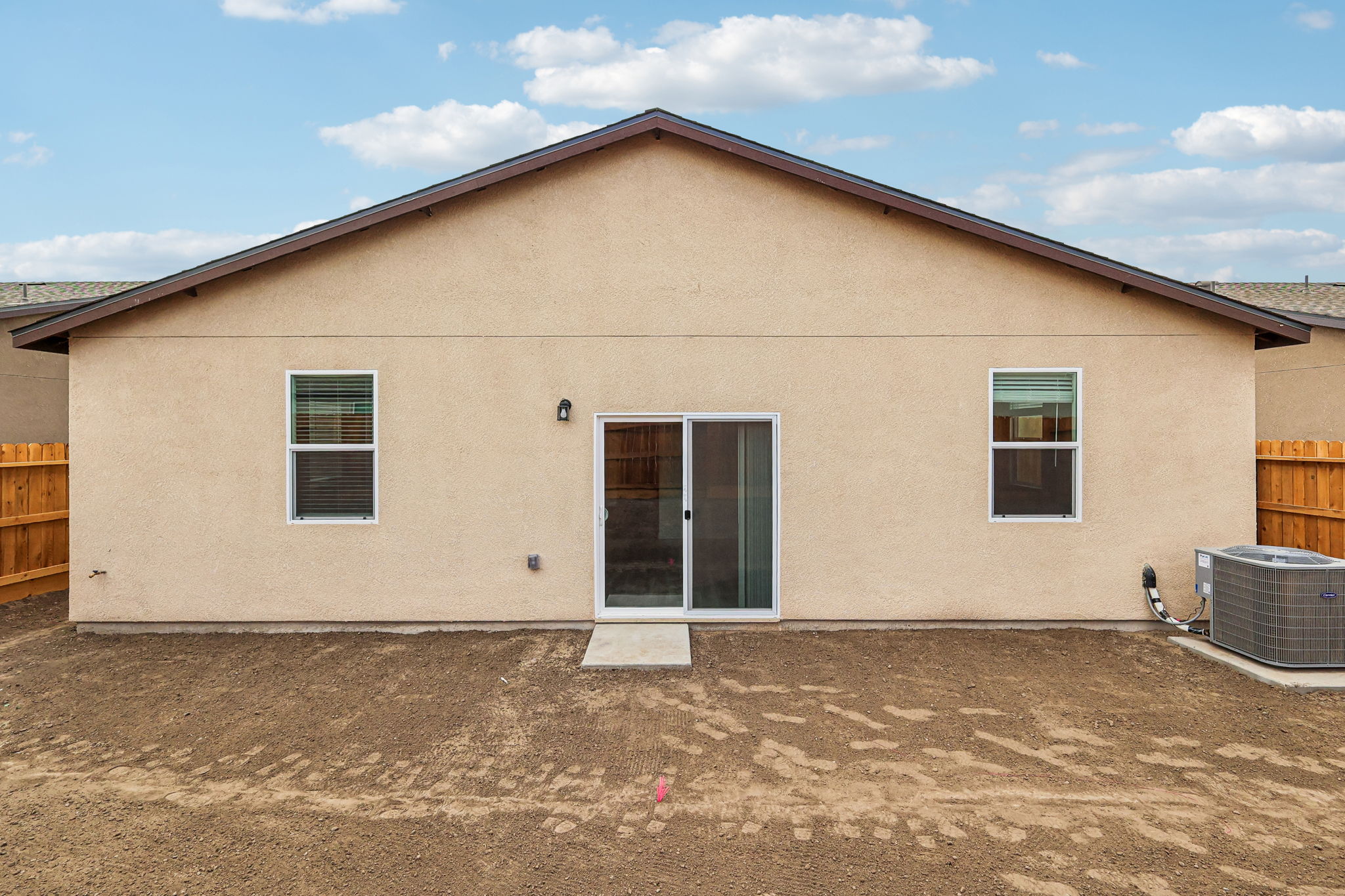A house with a dirt yard.
