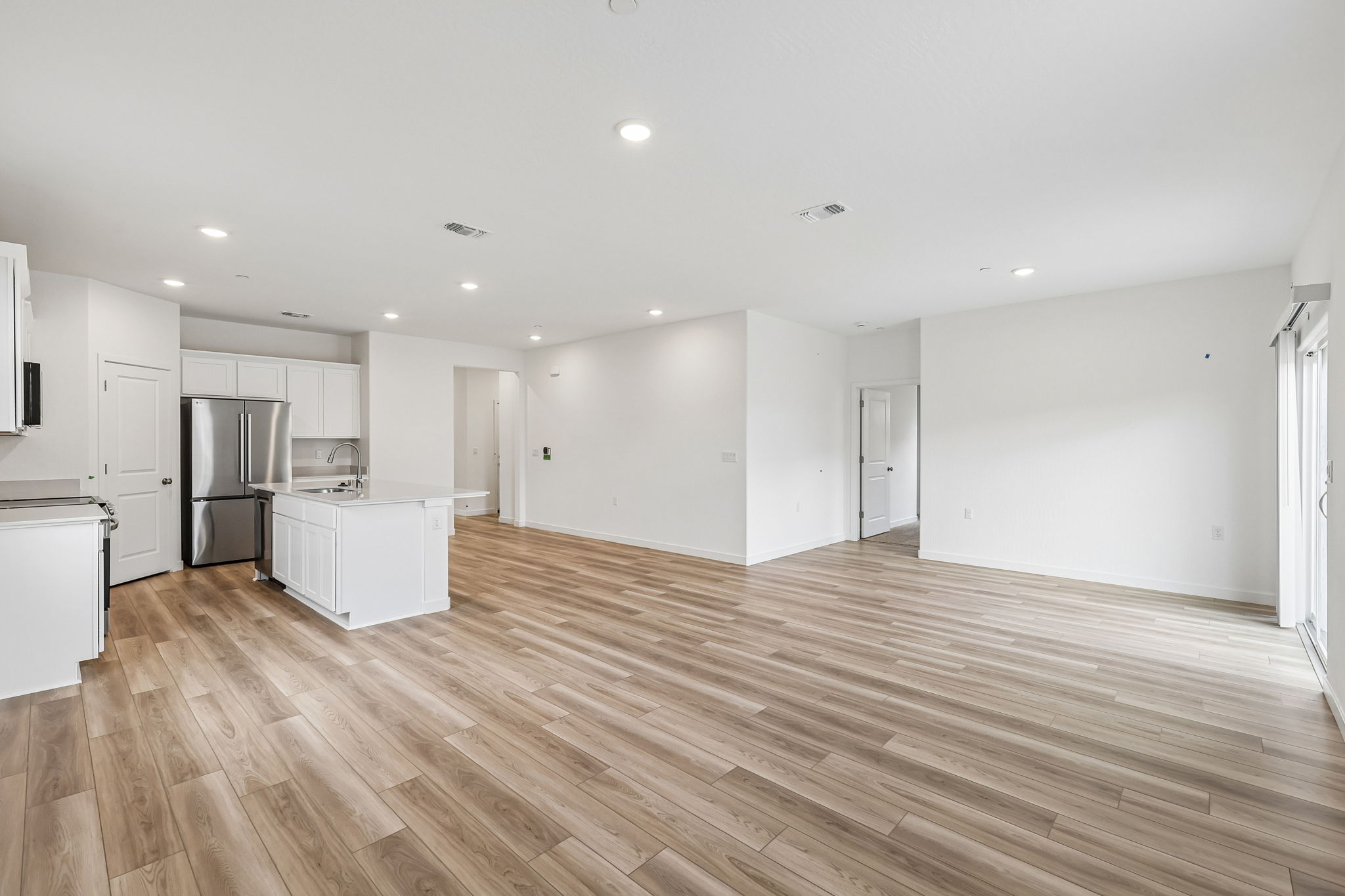 A large kitchen with white cabinets.