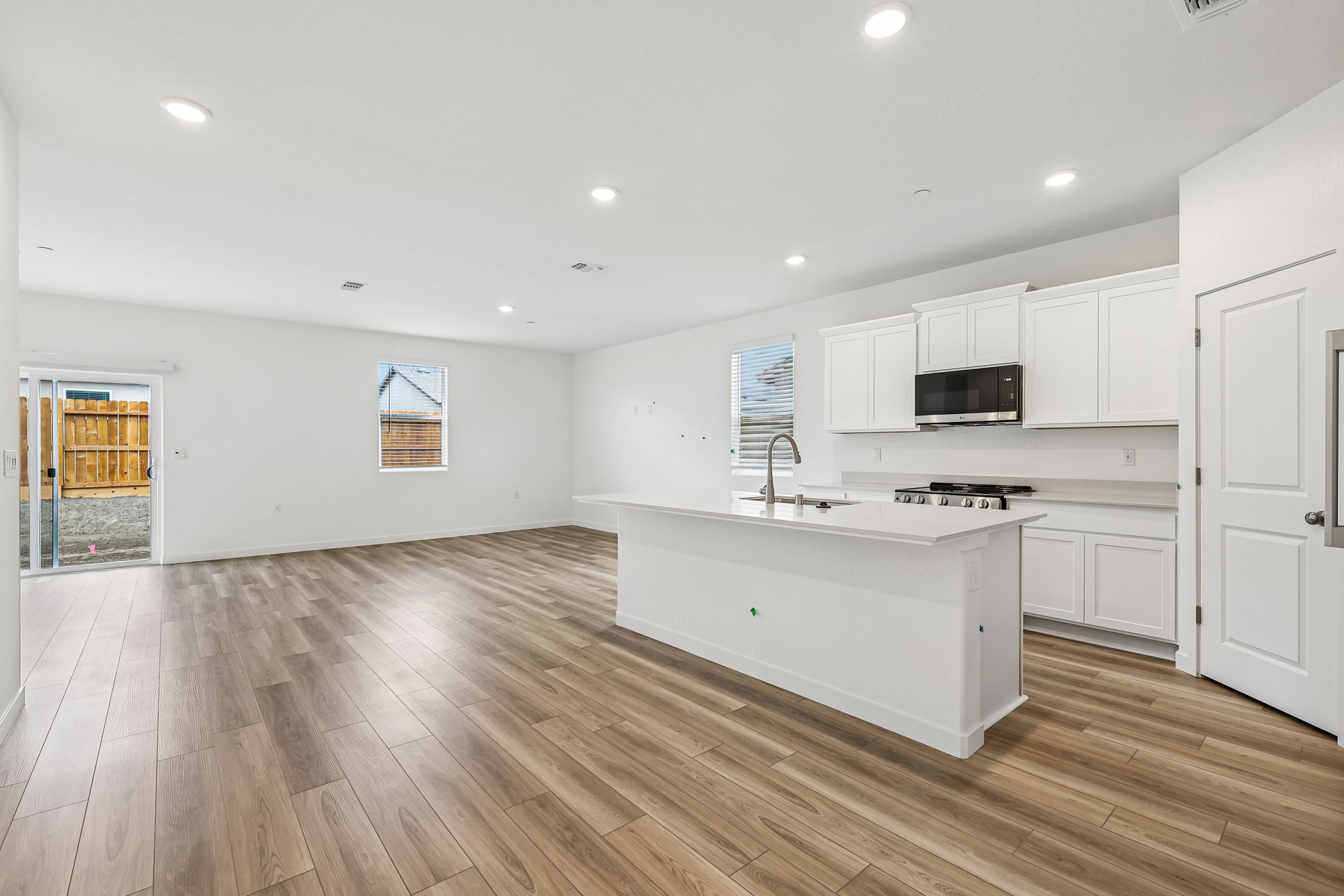 A kitchen with white cabinets.