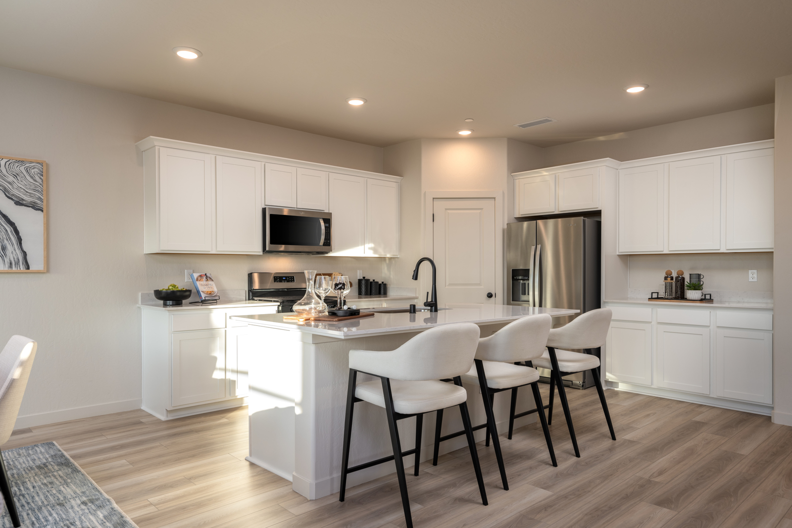 A kitchen with white cabinets.