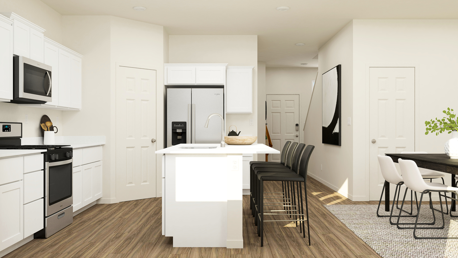 A kitchen with white cabinets.