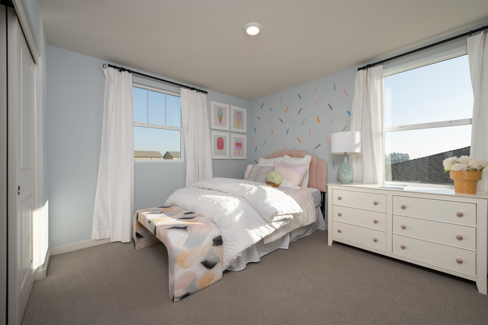 A bedroom with a bed and a window.