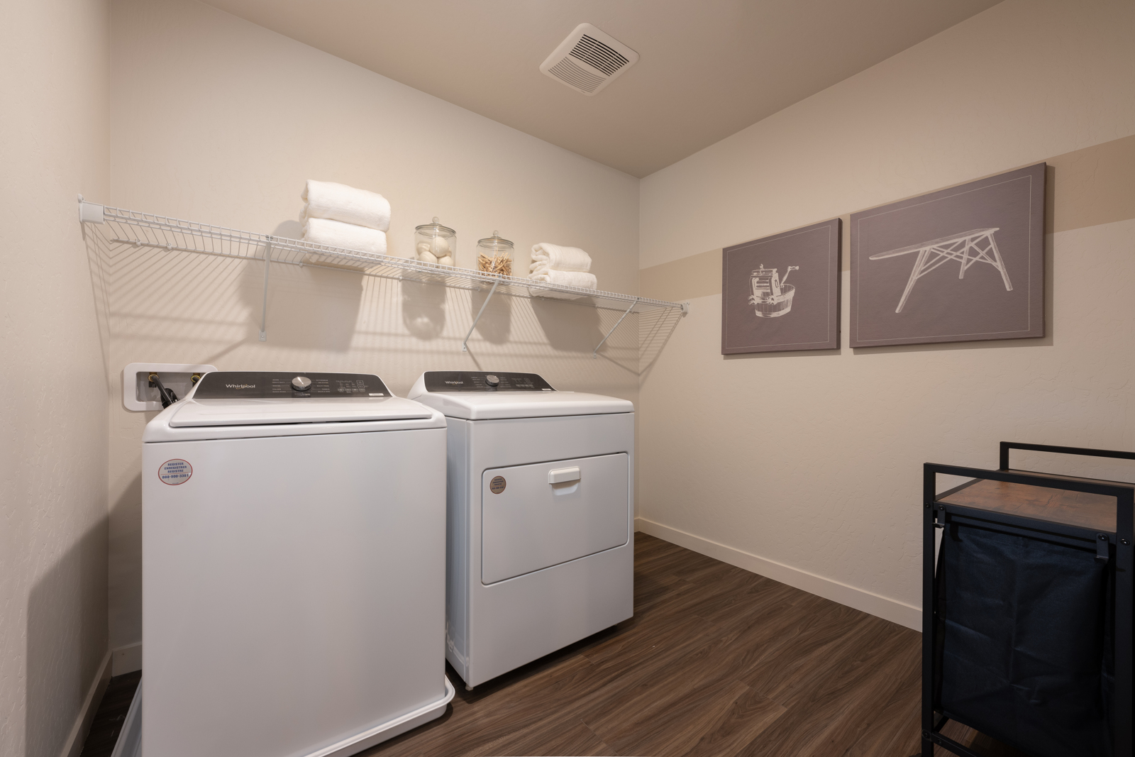 A kitchen with a white stove and white cabinets.