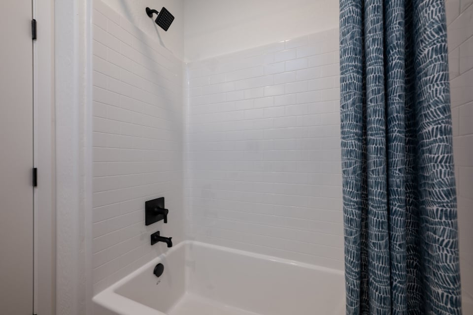 A bathtub in a bathroom.