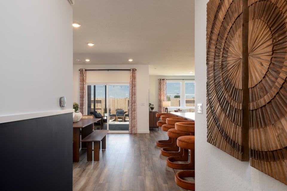 A room with a desk and chairs.