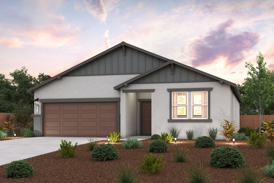 A house with a garage and bushes.