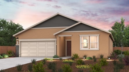 A house with a garage and a garden in front of it.