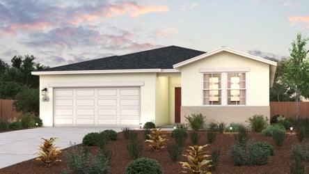 A house with a garage and bushes.