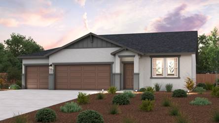 A house with a garage and bushes.