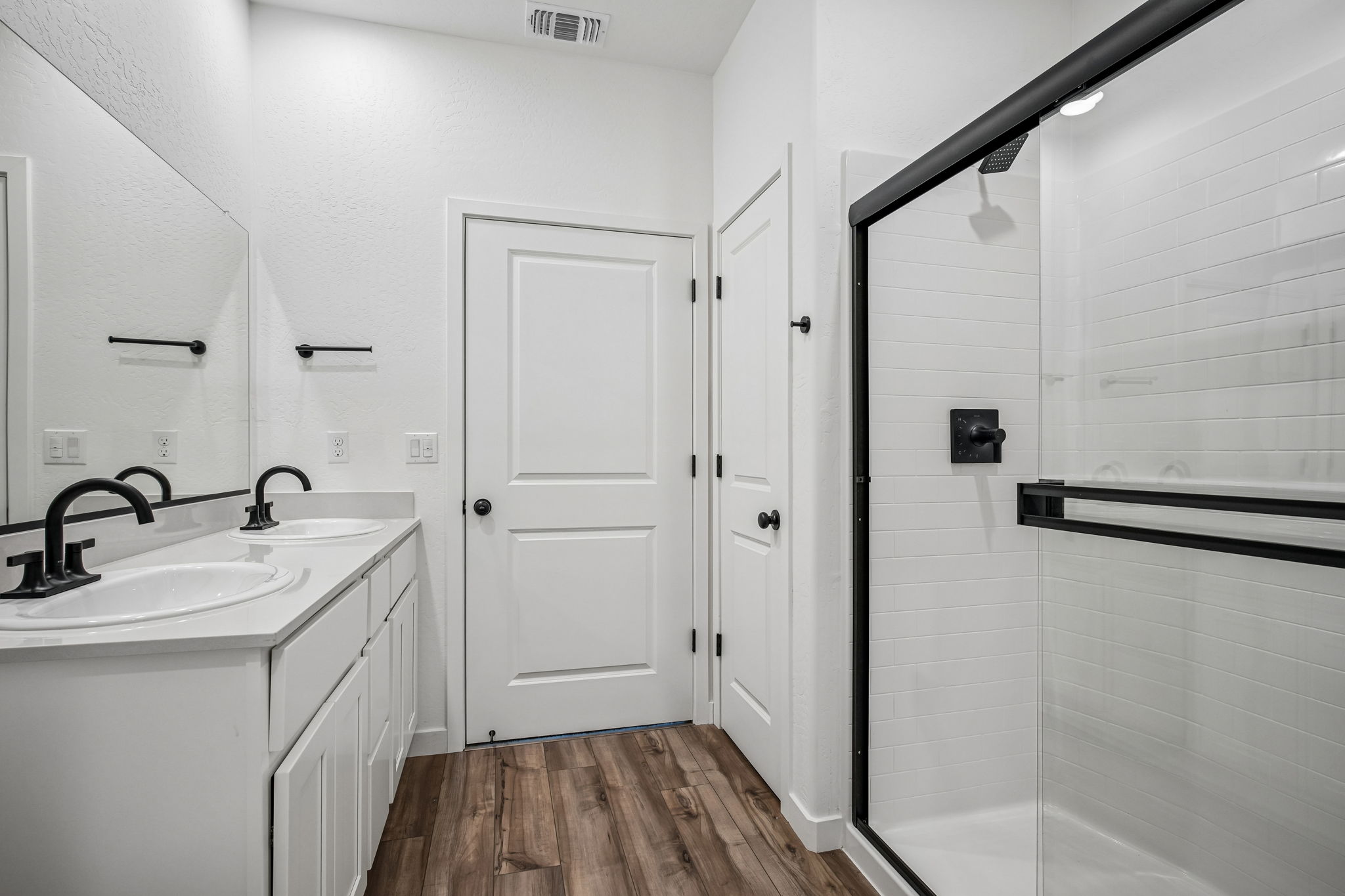 A bathroom with white cabinets.