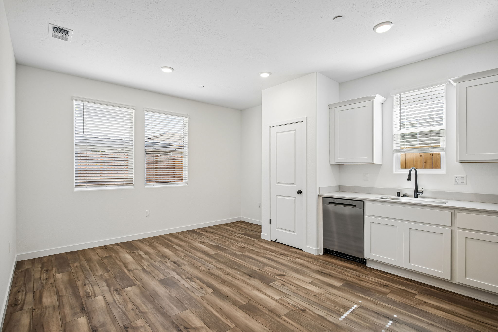 A kitchen with white cabinets.
