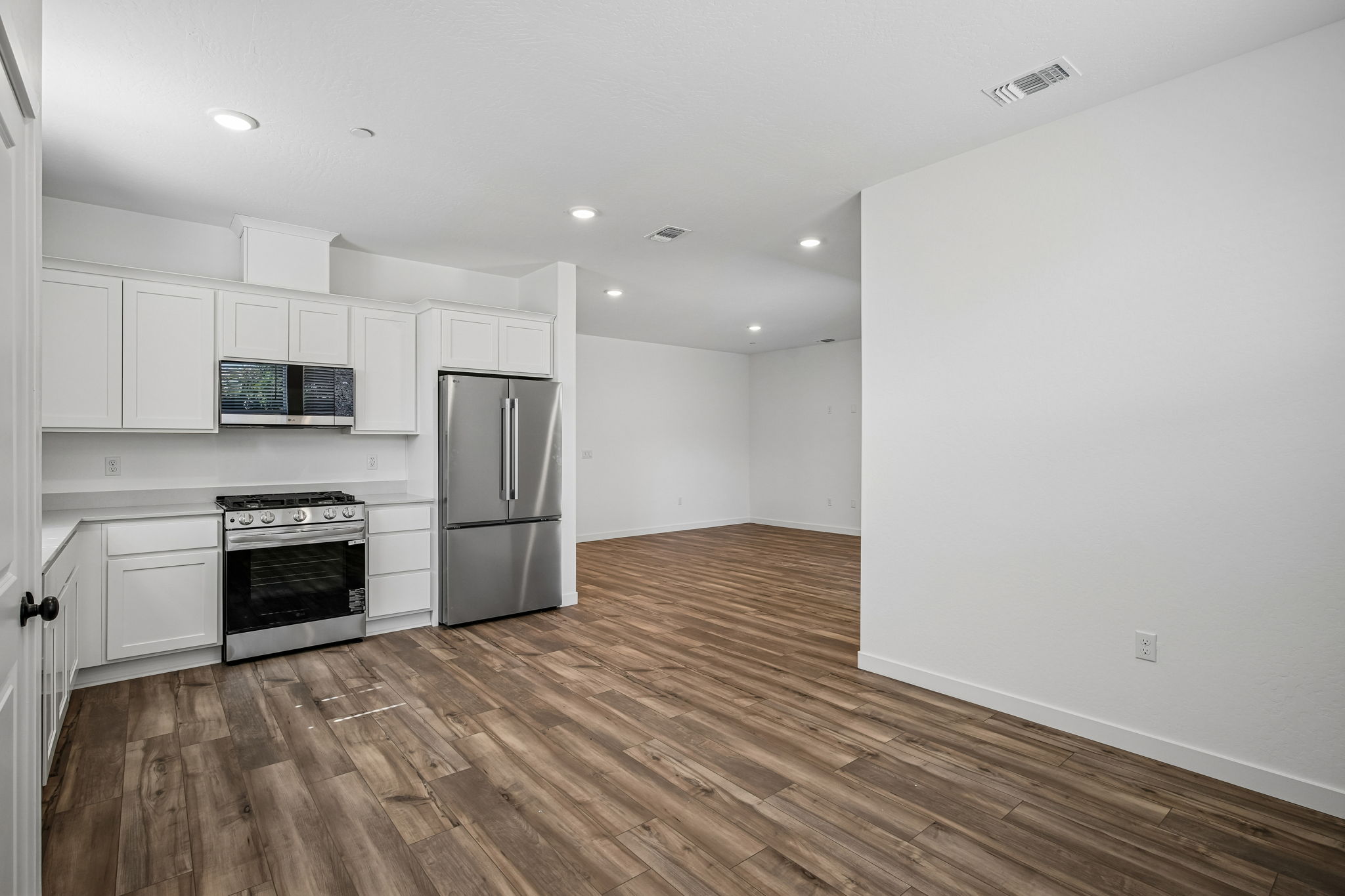 A kitchen with white cabinets.