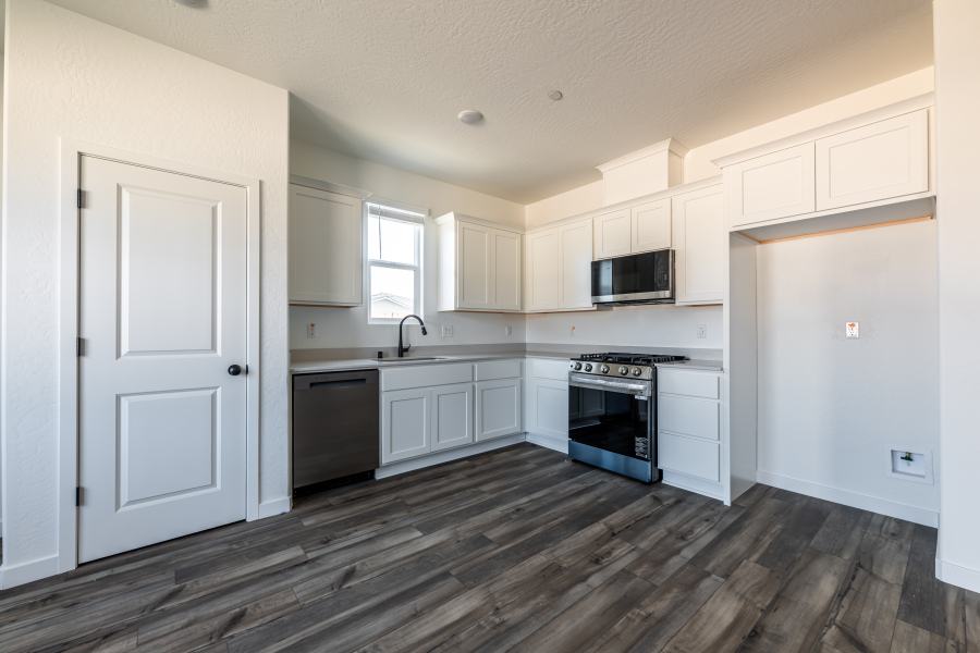 A kitchen with white cabinets.