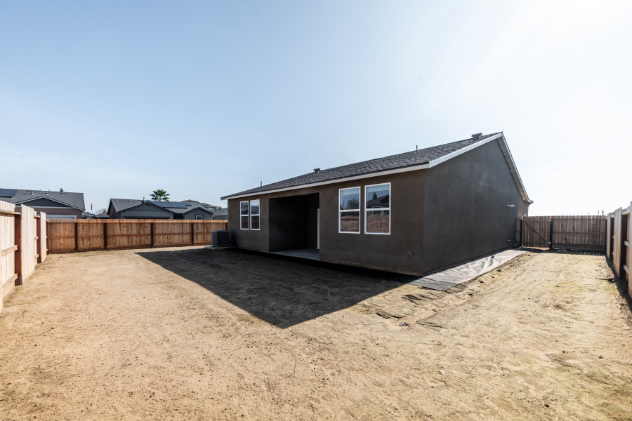 A house in a dirt field.