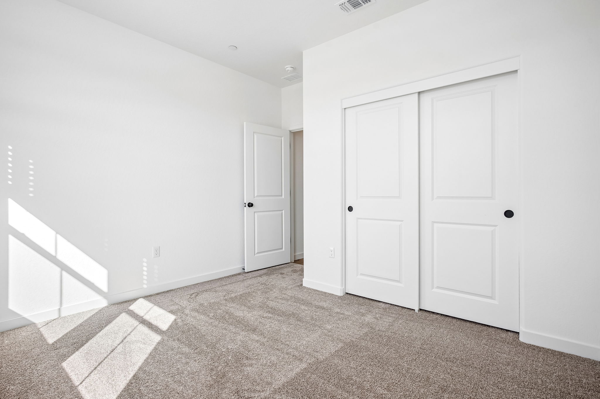 A hallway with white doors.