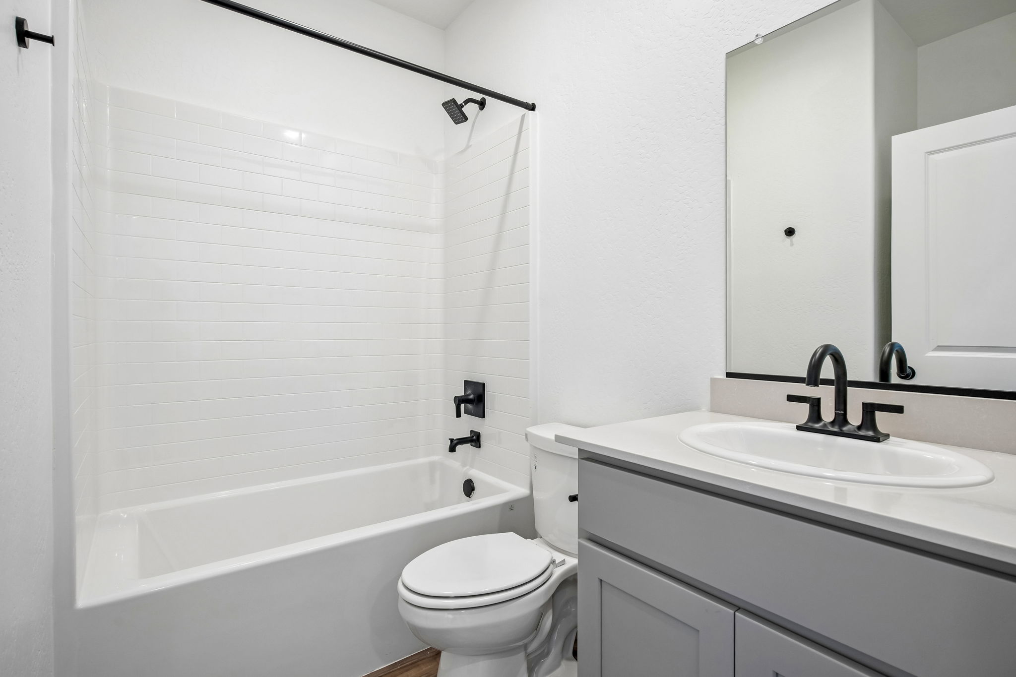 A bathroom with a sink toilet and bathtub.