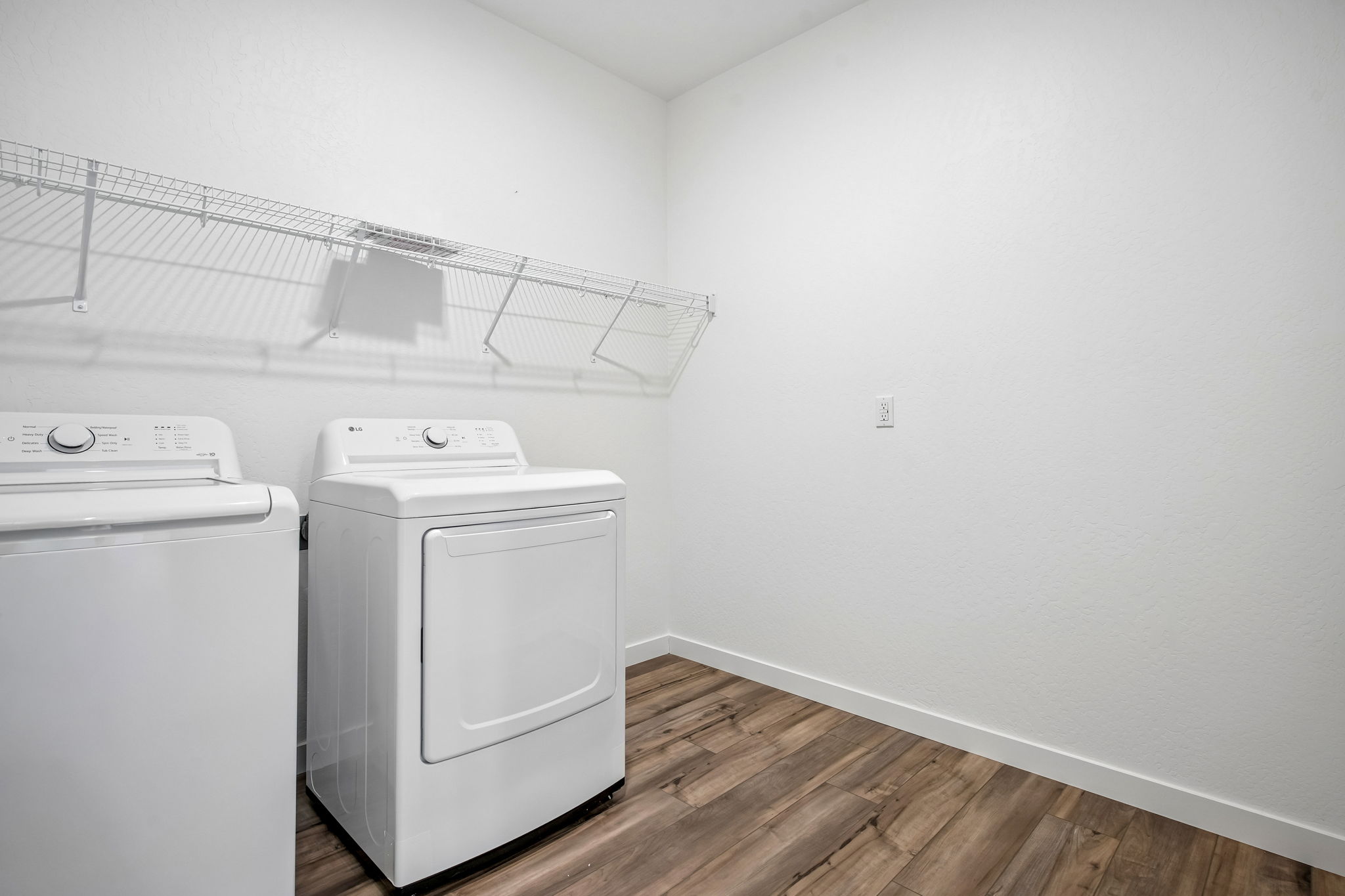 A white kitchen with a white refrigerator.