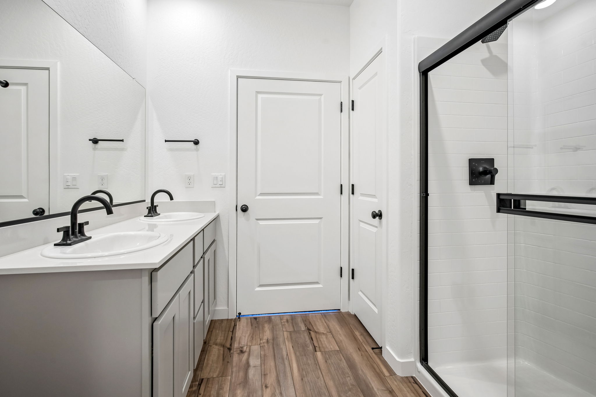 A bathroom with white cabinets.