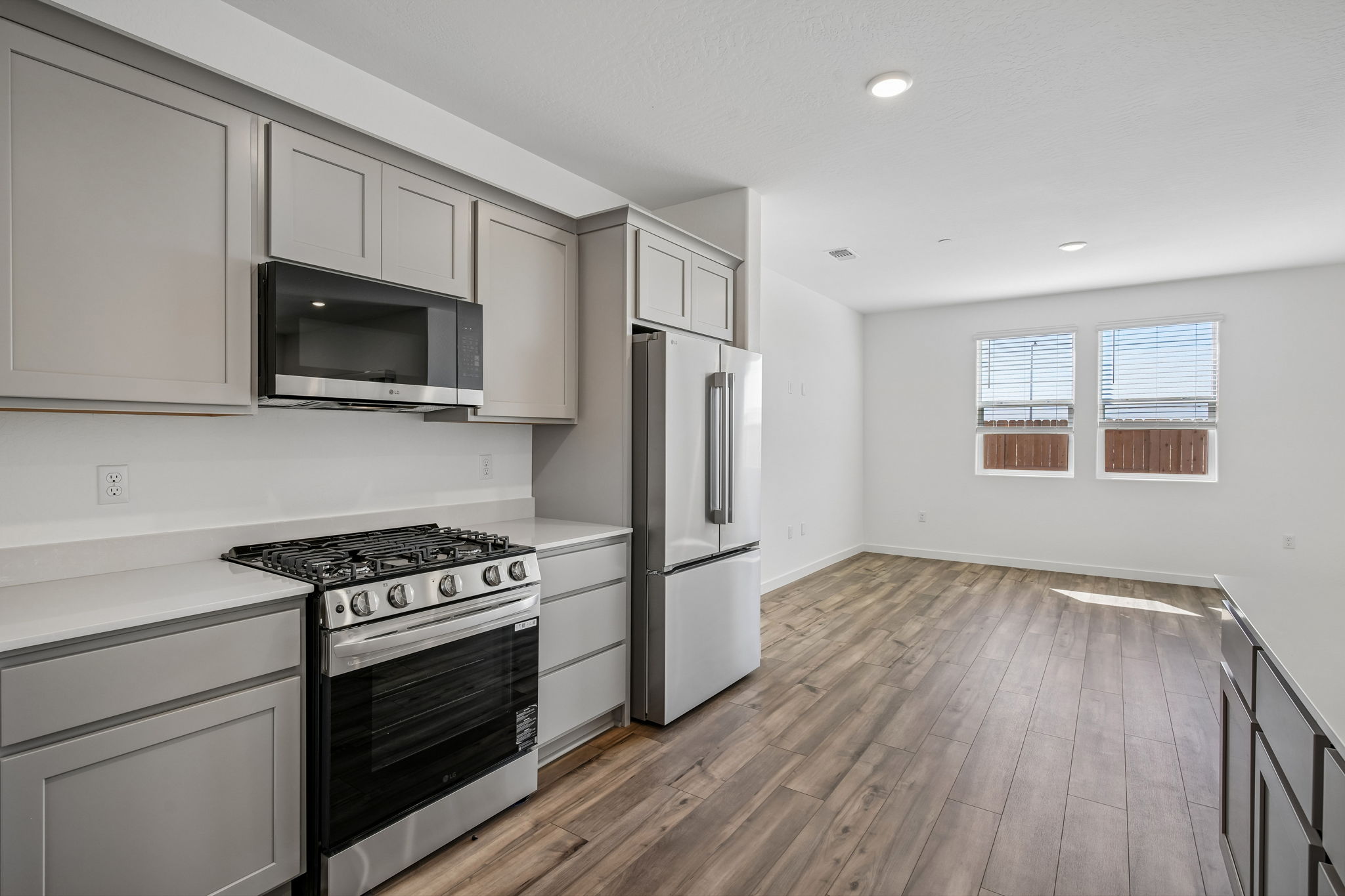 A kitchen with white cabinets.