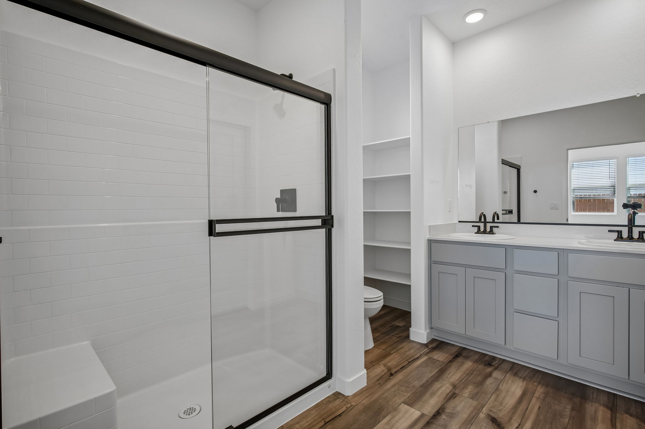 A bathroom with white cabinets.