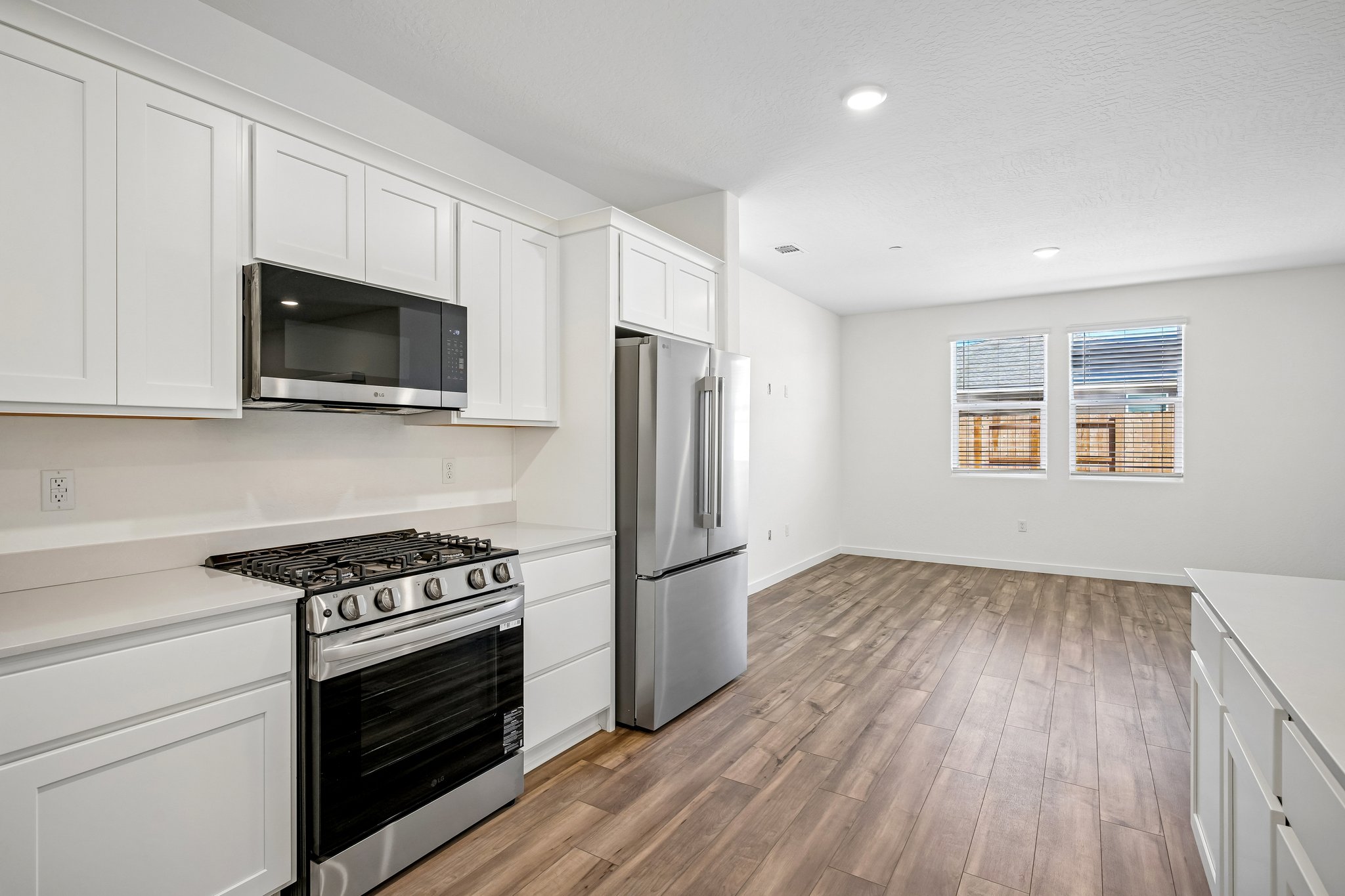 A kitchen with white cabinets.