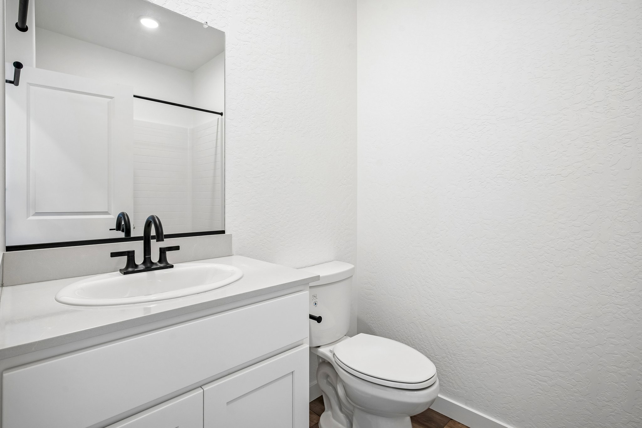 A bathroom with a sink and toilet.