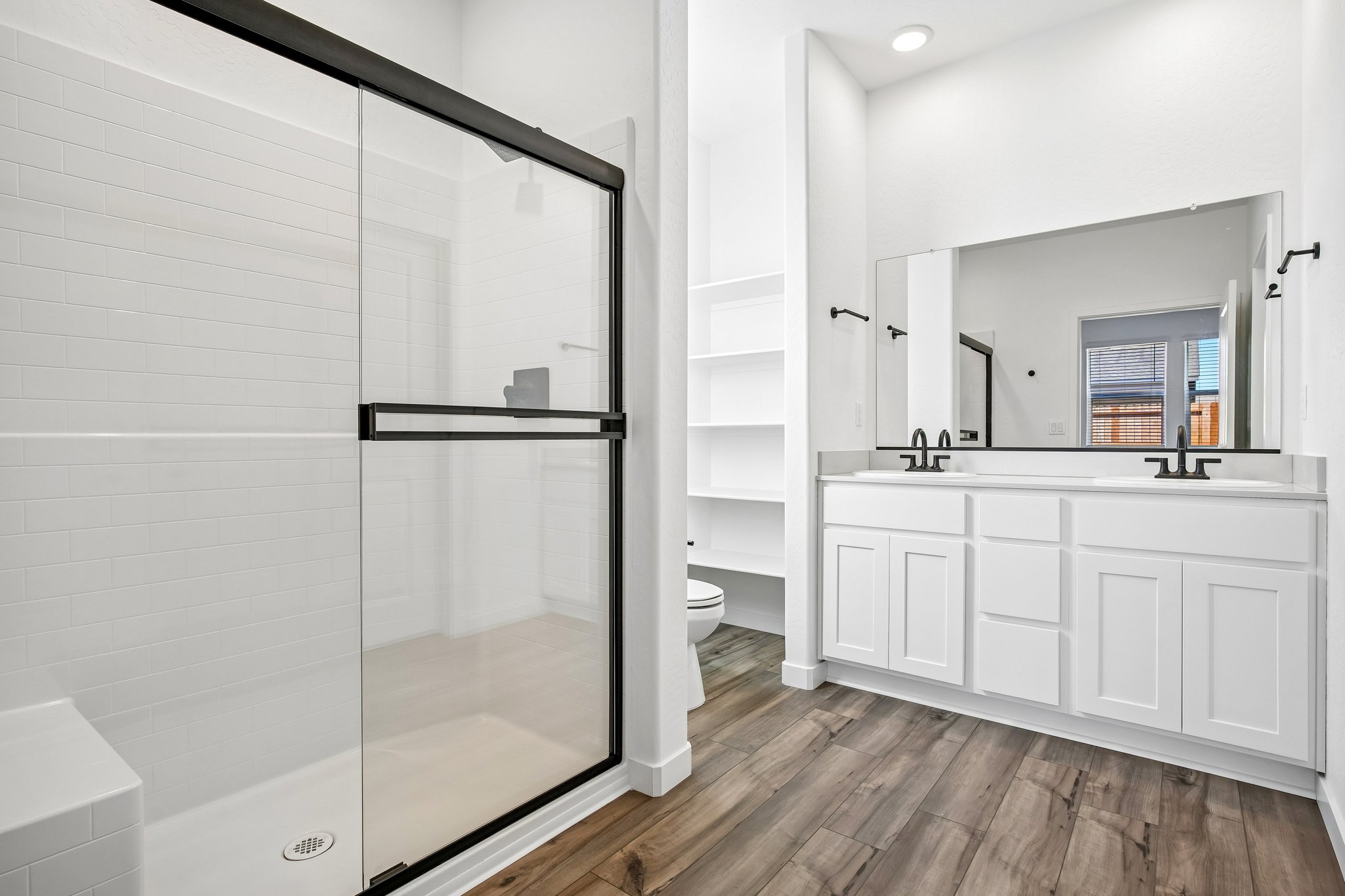 A bathroom with white cabinets.