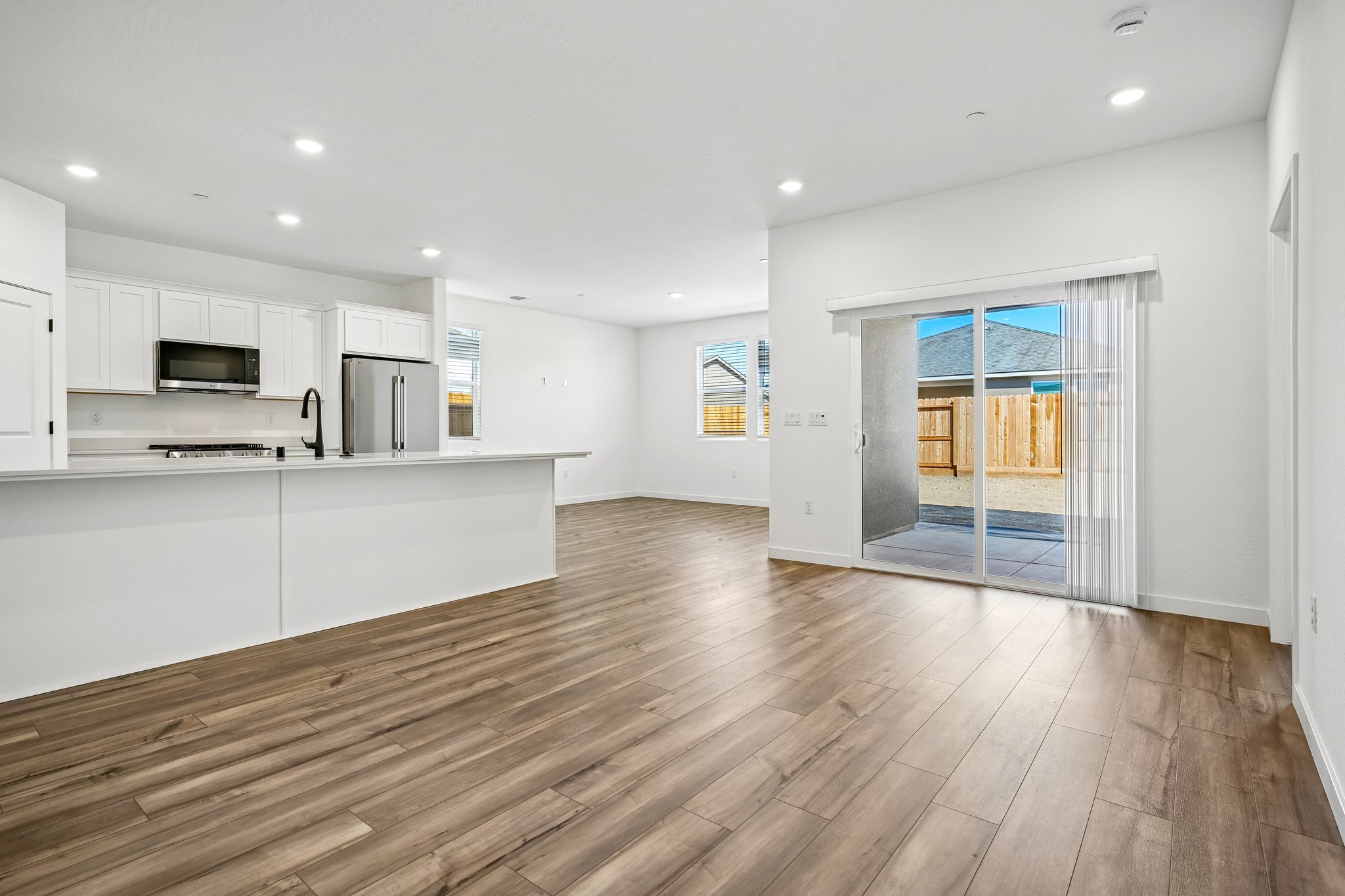 A large kitchen with a wood floor.
