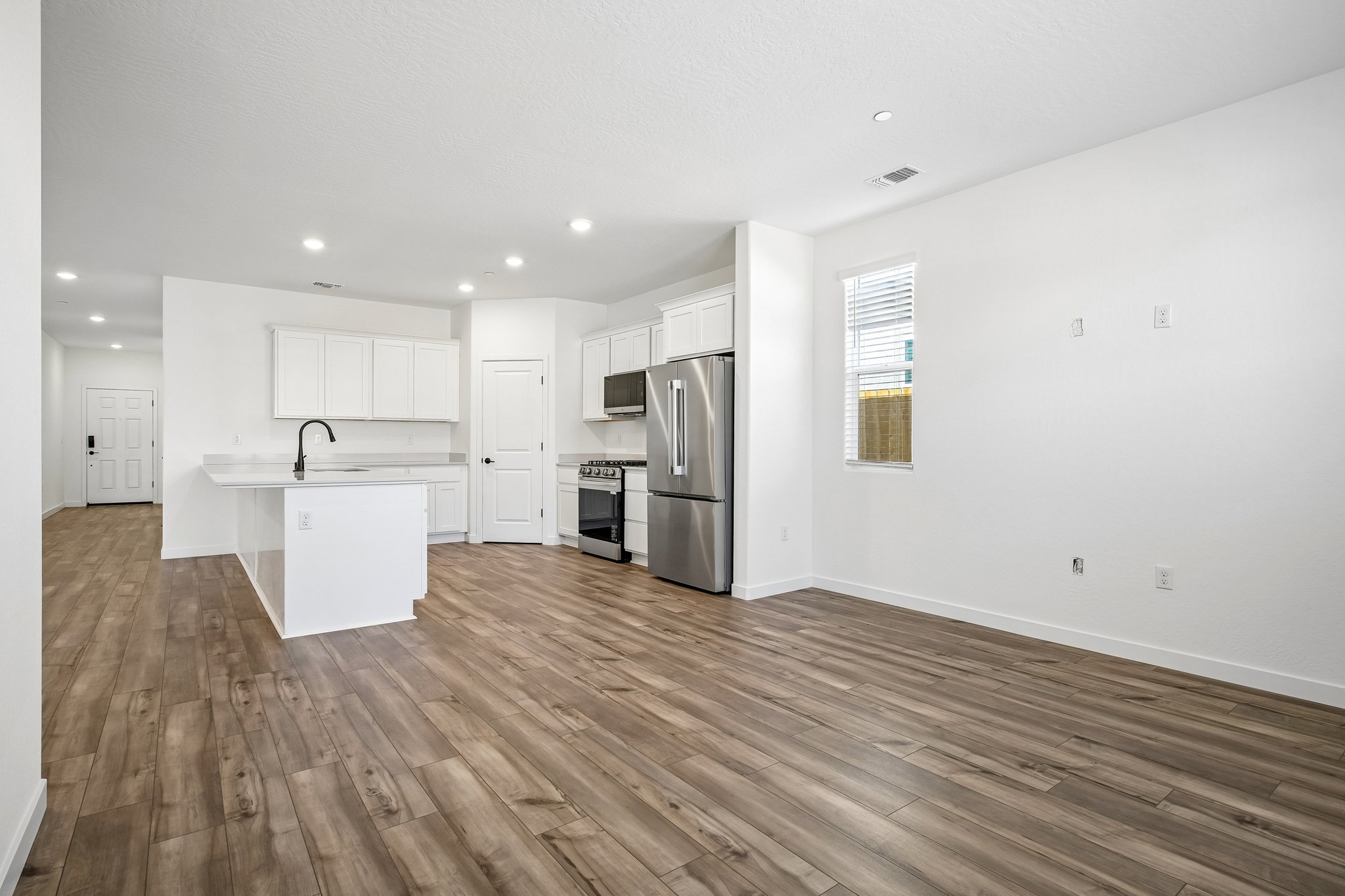 A kitchen with white cabinets.