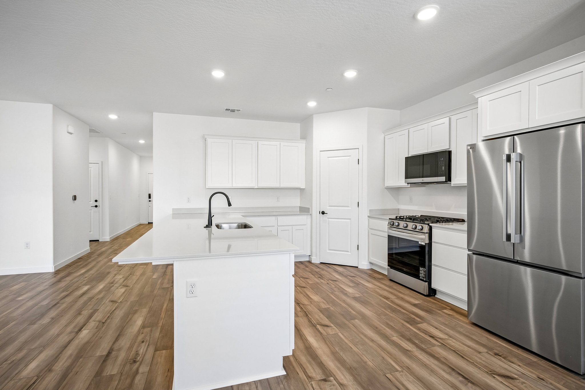 A kitchen with white cabinets.