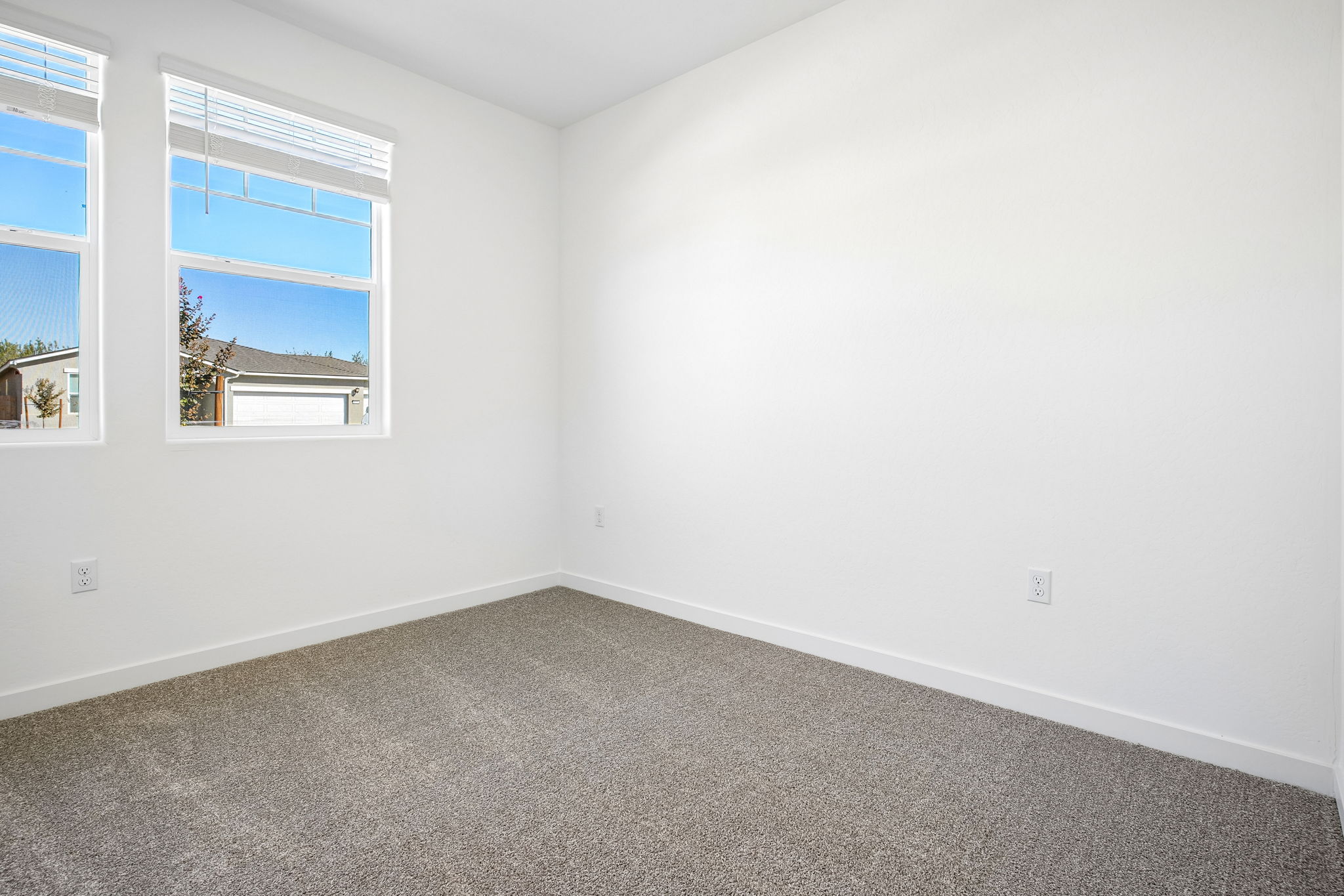 A room with a window and a carpet.