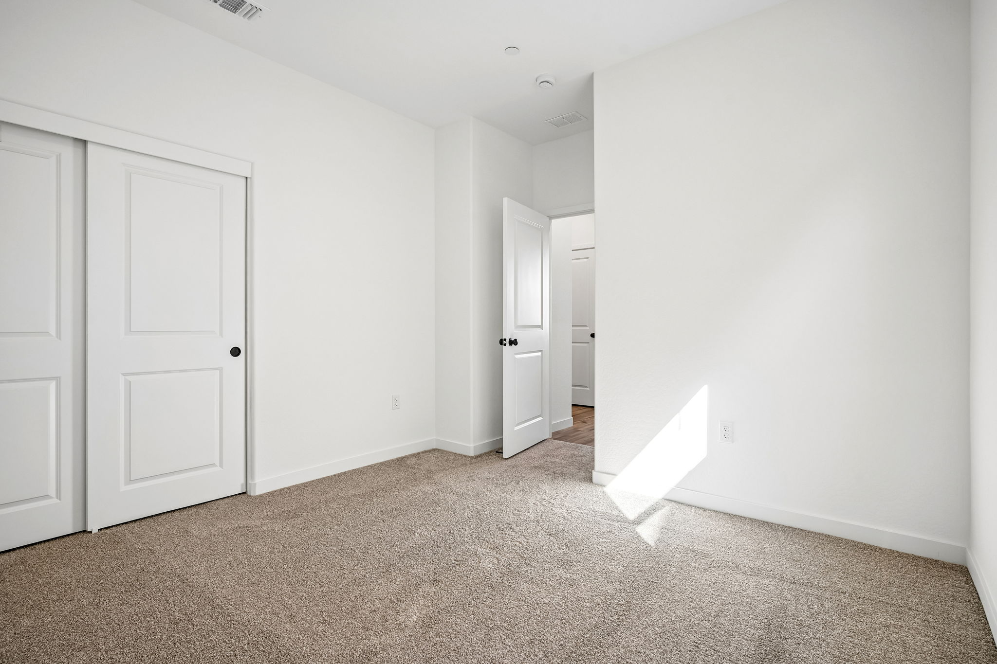 A hallway with white doors.