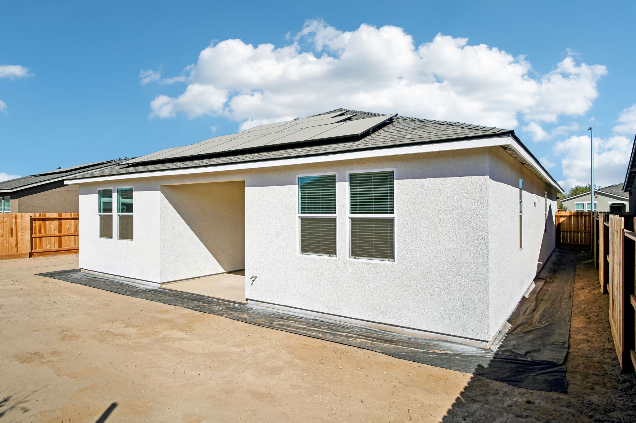 A white house with a black roof.