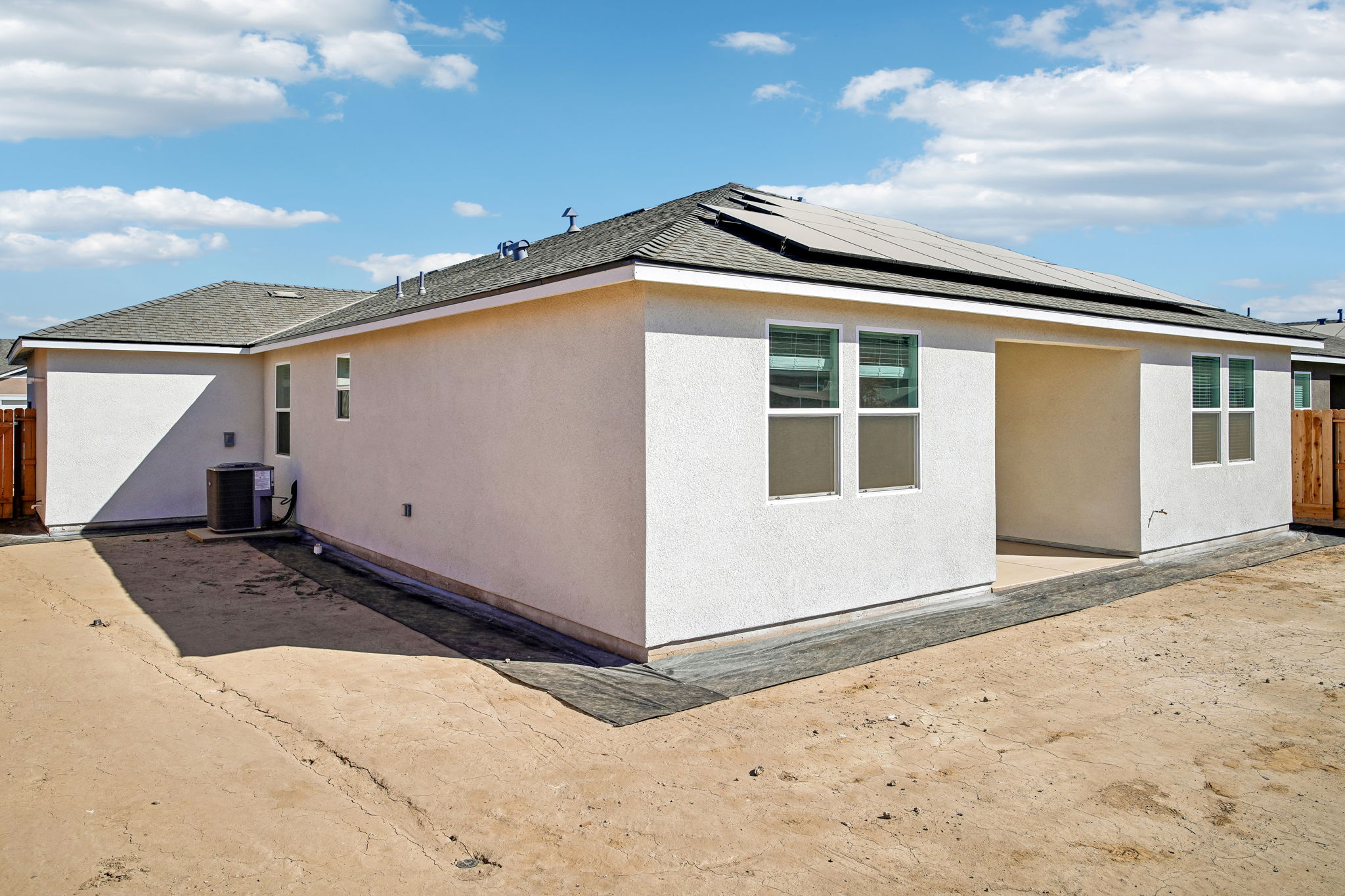 A building with a dirt lot.