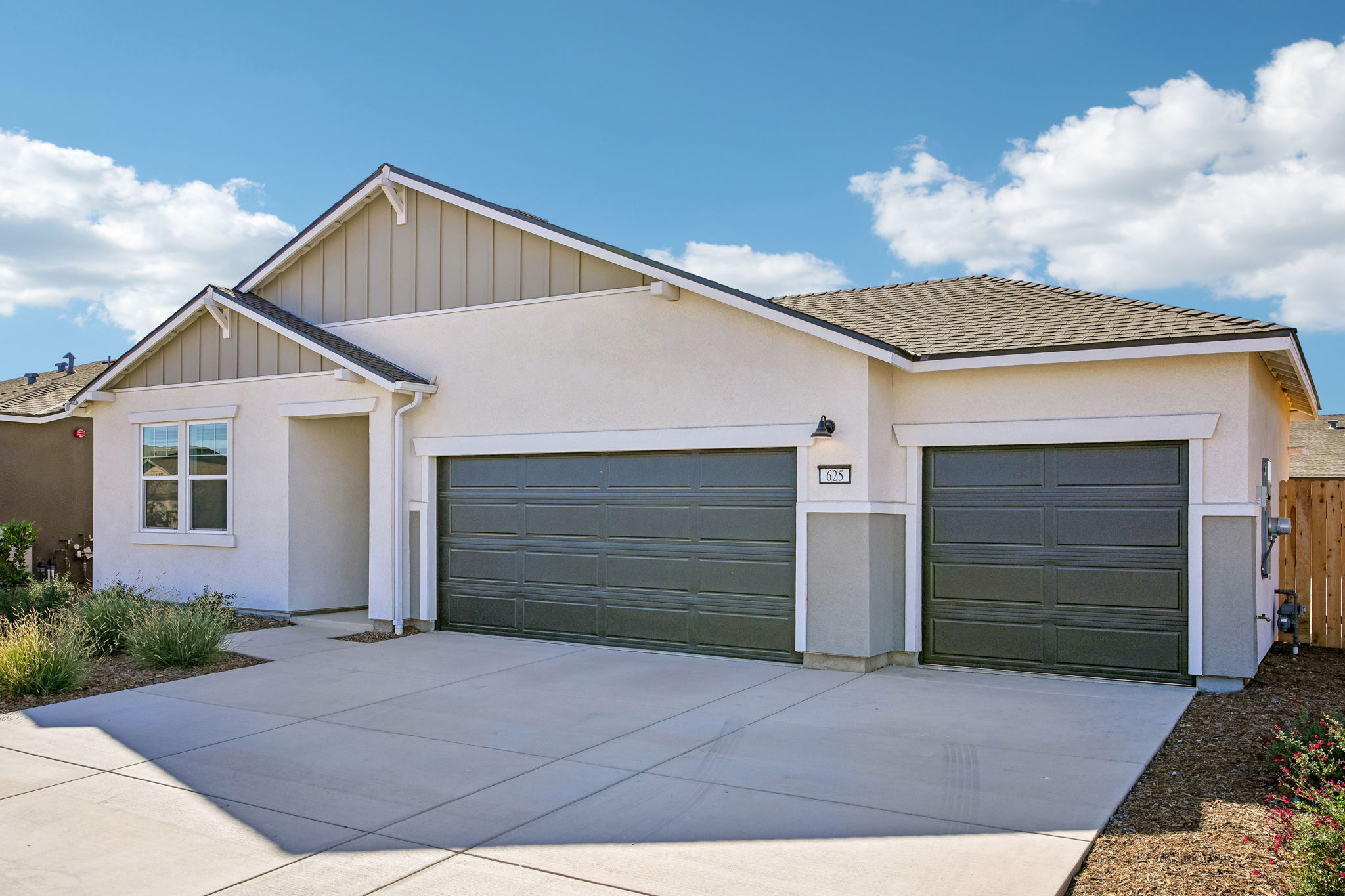 A house with garages and a driveway.