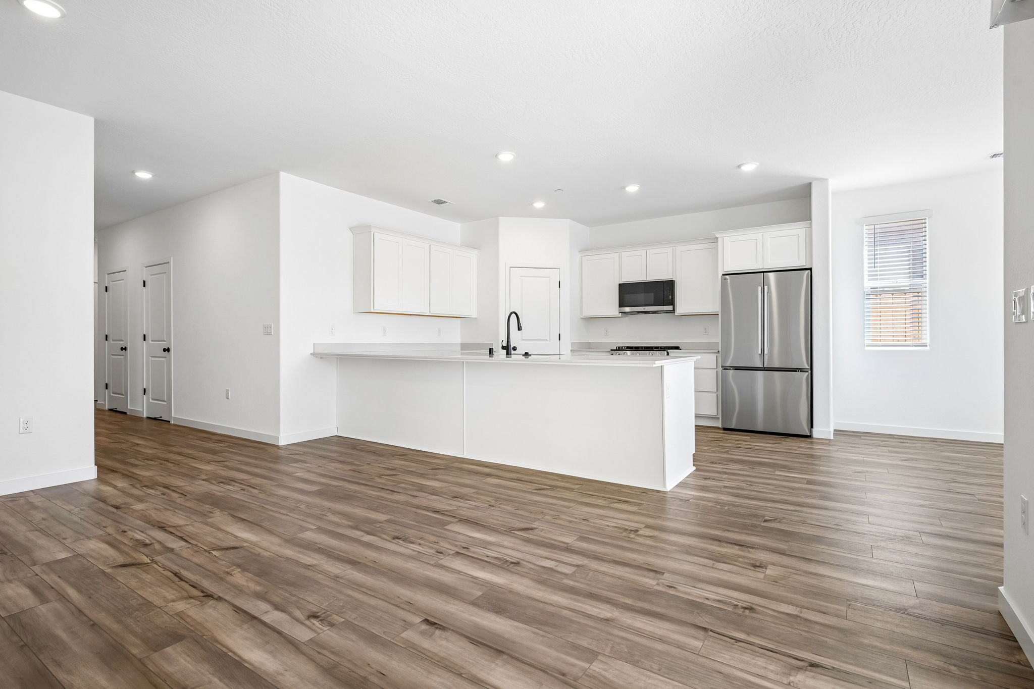 A kitchen with white cabinets.